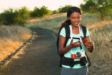 Hiker applying sunscreen